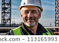electrician engineer against background towers, gray-haired man electrician works with white helmet head, construction, energy technology industry, energy businessman, construction engineer, work 113165993