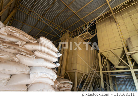 Chicken feed ingredients bags stacked in poultry feed mill plant. 113168111