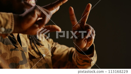 Male model showing heart shape sign on camera, presenting his love and sincere feelings. Young adult smiling and doing romantic symbol, being flirty and sweet. Handheld shot. Close up. Male model showing heart shape sign on camera, presenting his love and sincere feelings. Young adult smiling and doing romantic symbol, being flirty and sweet. Handheld shot. Close up. 113168229