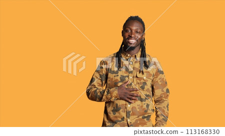 Confident male model laughing at jokes on camera, feeling happy and enjoying good times in studio. African american man acting silly and amusing over memes, having fun with laughs. Confident male model laughing at jokes on camera, feeling happy and enjoying good times in studio. African american man acting silly and amusing over memes, having fun with laughs. 113168330