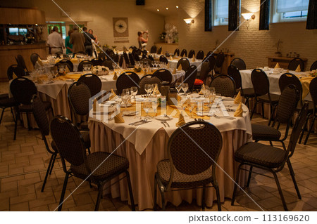 Elegant Reception: Ready for Celebration in a Beautifully Set Dining Hall 113169620