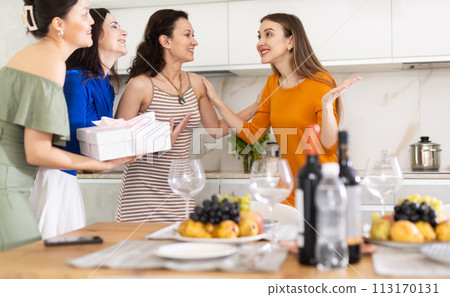 Three women have arrived for birthday celebration and presenting gift to birthday woman Three women have arrived for birthday celebration and presenting gift to birthday woman 113170131