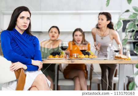 Portrait of an upset brunette woman who quarreled with her friends at party Portrait of an upset brunette woman who quarreled with her friends at party 113170163