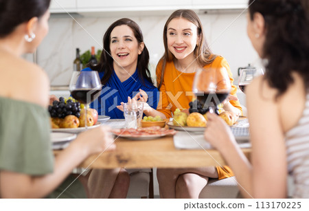 Female friends having fun at intimate house party Female friends having fun at intimate house party 113170225