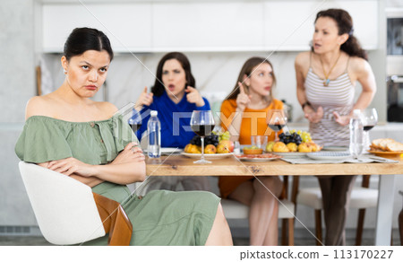 Friends quarrel at party. Upset woman listens to screams and indignation of her girlfriends Friends quarrel at party. Upset woman listens to screams and indignation of her girlfriends 113170227