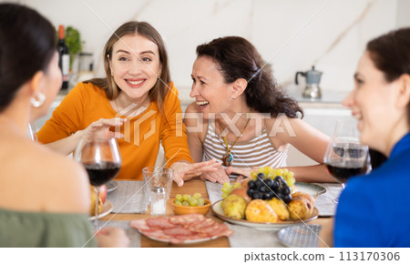 Female friends having fun at intimate house party 113170306