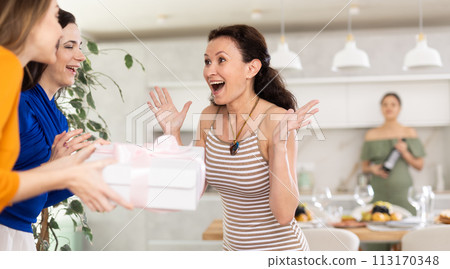 Group of women greeting each other and giving gift 113170348