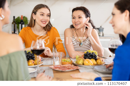Female friends having fun at intimate house party 113170407