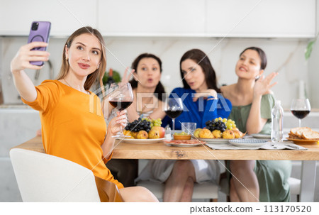 Young woman taking selfie with friends 113170520