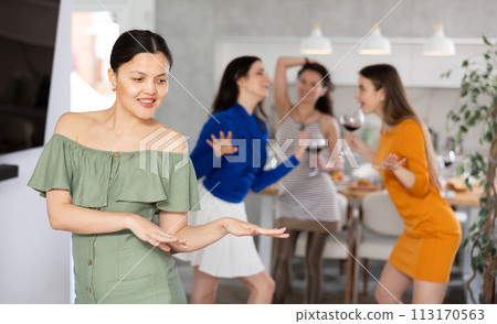 Woman have fun dancing during house party with female friends. Woman have fun dancing during house party with female friends. 113170563