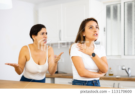 Woman ignoring her girlfriend standing in background and arguing with her Woman ignoring her girlfriend standing in background and arguing with her 113170600