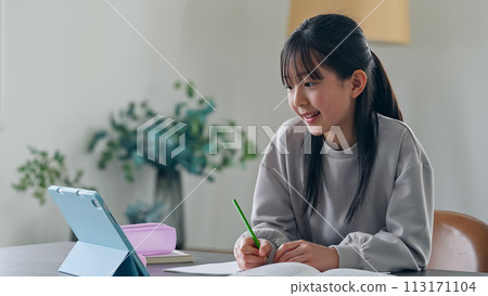 Girl studying while looking at a tablet PC 113171104