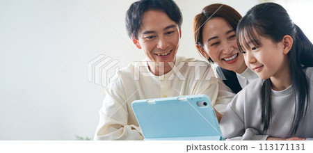 Family looking at tablet together 113171131