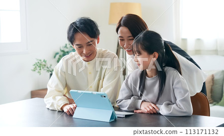 Family looking at tablet together Family looking at tablet together 113171132