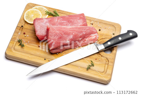Fresh tuna Fish steak on a wooden cutting serving board isolated on a white background Fresh tuna Fish steak on a wooden cutting serving board isolated on a white background 113172662