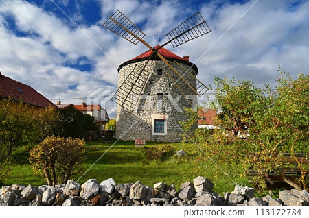 Beautiful old windmill and landscape with the sun. Ostrov u Macochy, Czech Republic. Europe. Beautiful old windmill and landscape with the sun. Ostrov u Macochy, Czech Republic. Europe. 113172784
