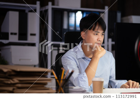 Businessman working overtime at his office He felt tired. 113172991