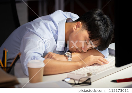 Businessman working overtime at his office He felt tired. 113173011