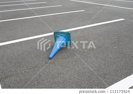 Blue triangular cone lying in the parking lot Blue triangular cone lying in the parking lot 113173924