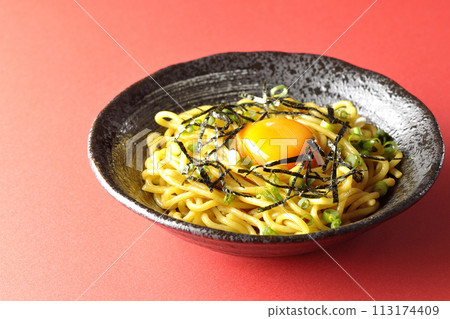 Abura soba topped with egg yolk, shredded seaweed, and green onions 113174409