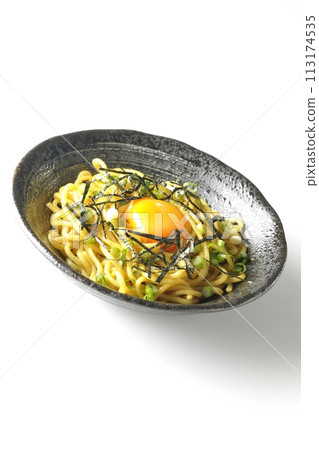 Abura-soba noodles topped with egg yolk, shredded seaweed, and green onions photographed against a white background Abura-soba noodles topped with egg yolk, shredded seaweed, and green onions photographed against a white background 113174535