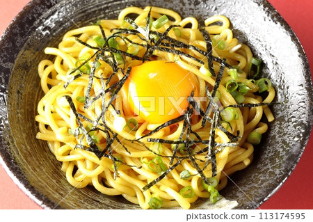 A bird's-eye view of abura soba noodles topped with egg yolk, shredded nori seaweed, and green onions A bird's-eye view of abura soba noodles topped with egg yolk, shredded nori seaweed, and green onions 113174595
