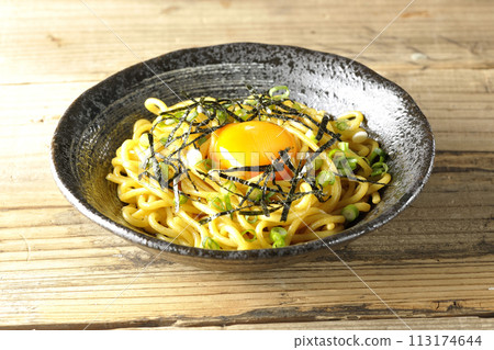 Abura soba topped with egg yolk, shredded seaweed, and green onions 113174644