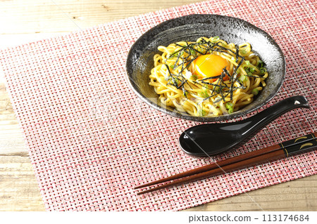 Abura soba topped with egg yolk, shredded seaweed, and green onions 113174684