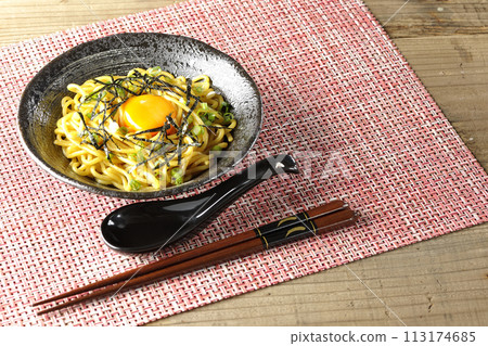 Abura soba topped with egg yolk, shredded seaweed, and green onions 113174685
