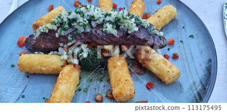 Gourmet steak and crispy polenta on rustic plate Gourmet steak and crispy polenta on rustic plate 113175495