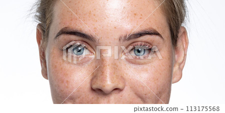 A close up of a person with blue eyes looking at the camera A close up of a person with blue eyes looking at the camera 113175568