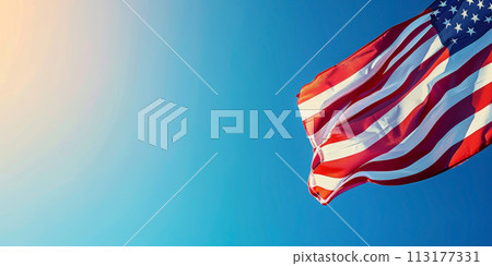 American flag waving against a clear blue sky. 113177331