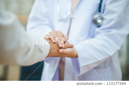 doctor hand holding the patient's hand. To encourage and comfort the patient so that the patient is not sad and worried. 113177394