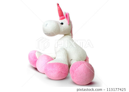 Pink soft unicorn toy sitting at white background. Isolated studio image Pink soft unicorn toy sitting at white background. Isolated studio image 113177425