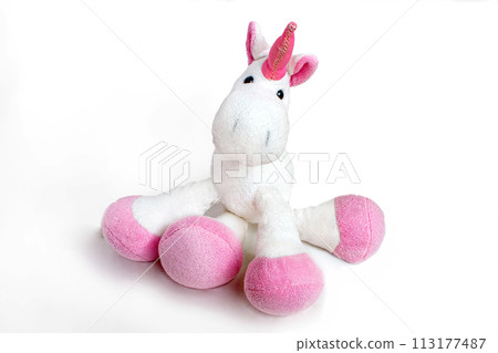 Pink soft unicorn toy sitting at white background. Isolated studio image Pink soft unicorn toy sitting at white background. Isolated studio image 113177487