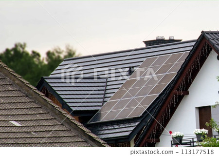 Historic farm house with modern solar panels on roof and wall 113177518