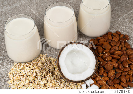 Types of plant-based milk in glasses. Oat, coconut and almond milk. Types of plant-based milk in glasses. Oat, coconut and almond milk. 113178388