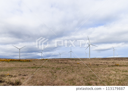 Wind turbines blend with natural landscapes, showcasing eco-friendly power generation Wind turbines blend with natural landscapes, showcasing eco-friendly power generation 113179887