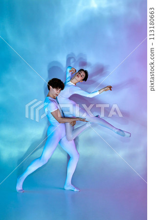 Dynamic portrait of male and female ballet dancers in pastel leotards performing lift against gradient background. 113180663