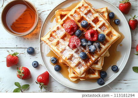 Wake to a morning delight with freshly baked waffles adorned with berries and syrup drizzle, cafe menu 113181294