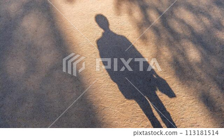 shadow of a person falling on the ground 113181514