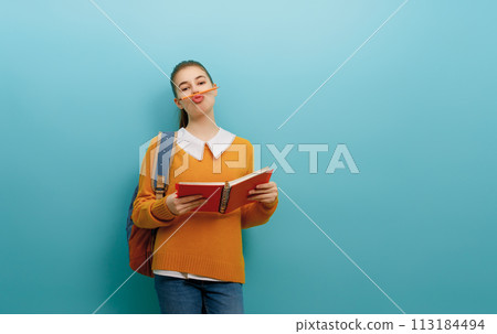 teenager on color paper wall background teenager on color paper wall background 113184494