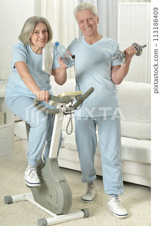 Portrait of happy sporty senior couple exercising 113186409