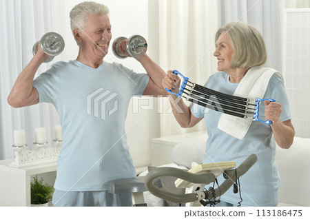 Portrait of happy sporty senior couple exercising Portrait of happy sporty senior couple exercising 113186475