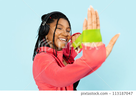 Woman Stretching Fitness Rubber Band and Enjoying Music with Headphones Woman Stretching Fitness Rubber Band and Enjoying Music with Headphones 113187047