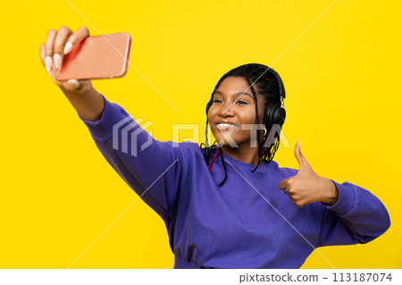 Woman Taking Selfie on Her Phone with a Trumb Up Woman Taking Selfie on Her Phone with a Trumb Up 113187074