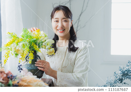 A woman with a flower arrangement A woman with a flower arrangement 113187687