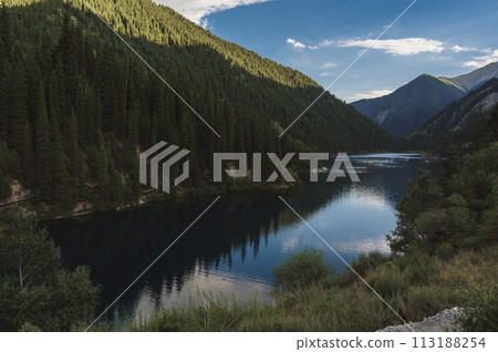 beautiful panoramic landscape with Kolsai Lake in the Tien Shan mountains in Kazakhstan on summer evening beautiful panoramic landscape with Kolsai Lake in the Tien Shan mountains in Kazakhstan on summer evening 113188254