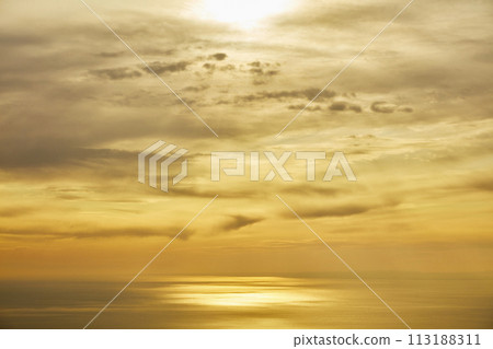 Sunset and ocean seen through the clouds Sunset and ocean seen through the clouds 113188311