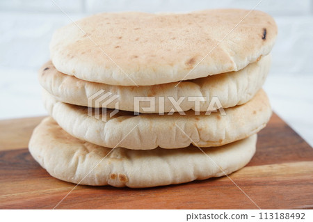 A stack of Pita bread(flat bread) on wooden board 113188492